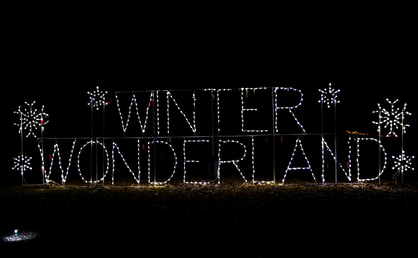Festive lights spelling "Winter Wonderland" with snowflakes on a dark background.