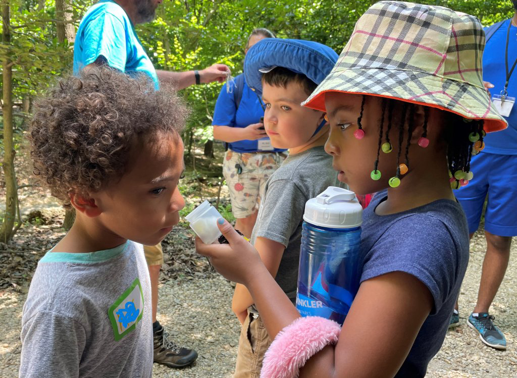 A boy and a girl exploring their sense of smell